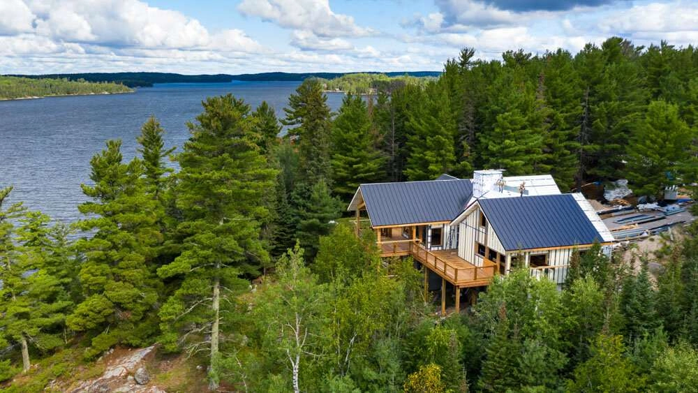 Panels being installed on roof of cabin. © robert lowdon