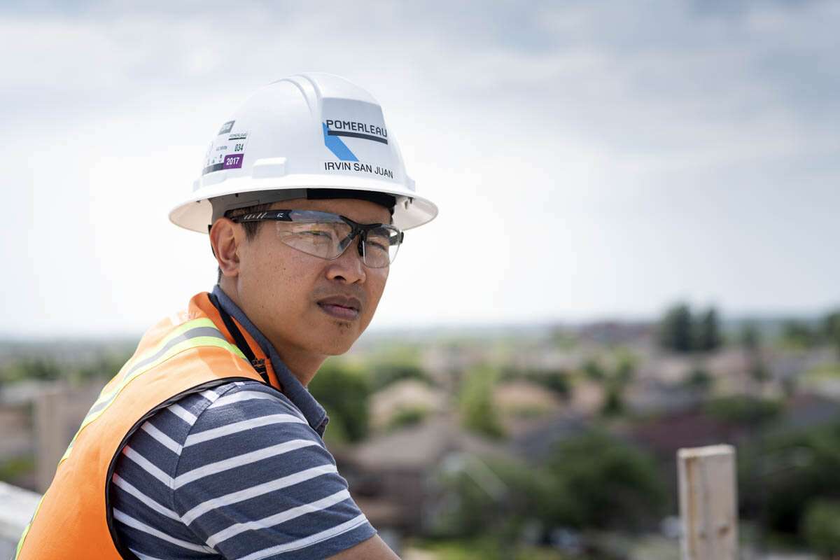 Construction foreman on the roof top of a new building. © robert lowdon