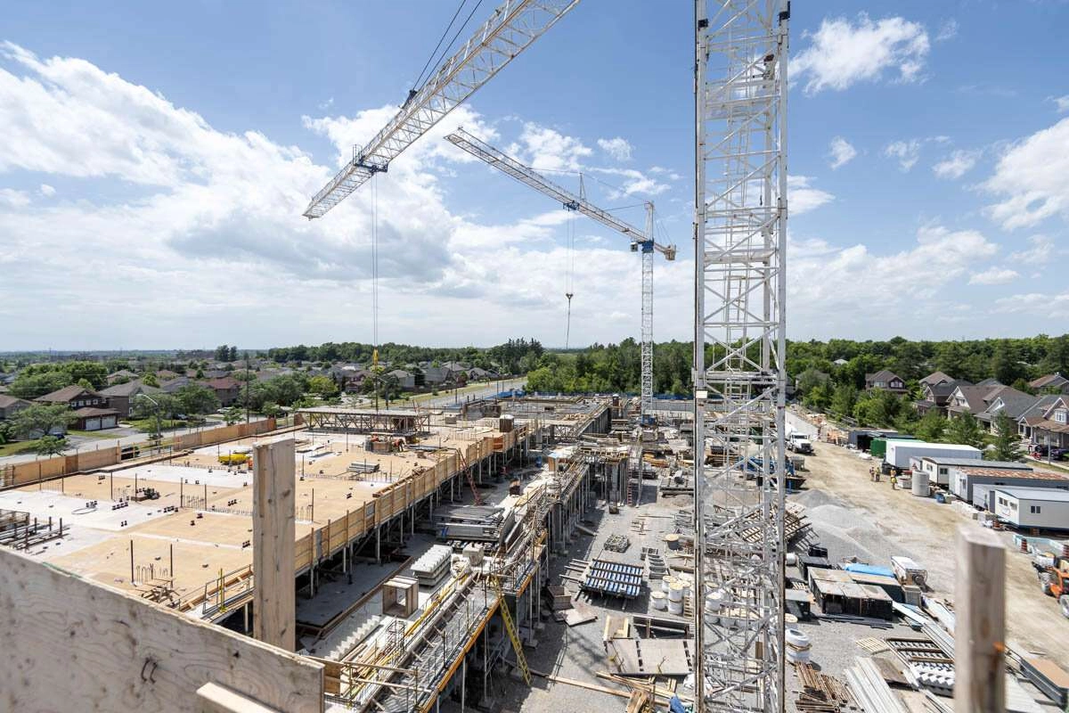 Large cranes move work supplies and concrete throughout the work site. © robert lowdon