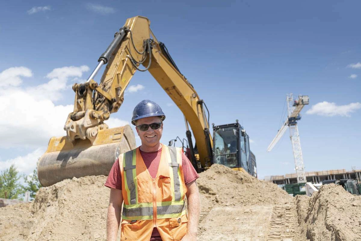 An operator of an excavator in front of his machine. © robert lowdon