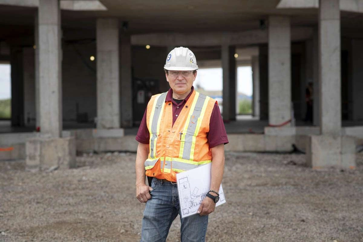 A worker holding architectural plans. © robert lowdon