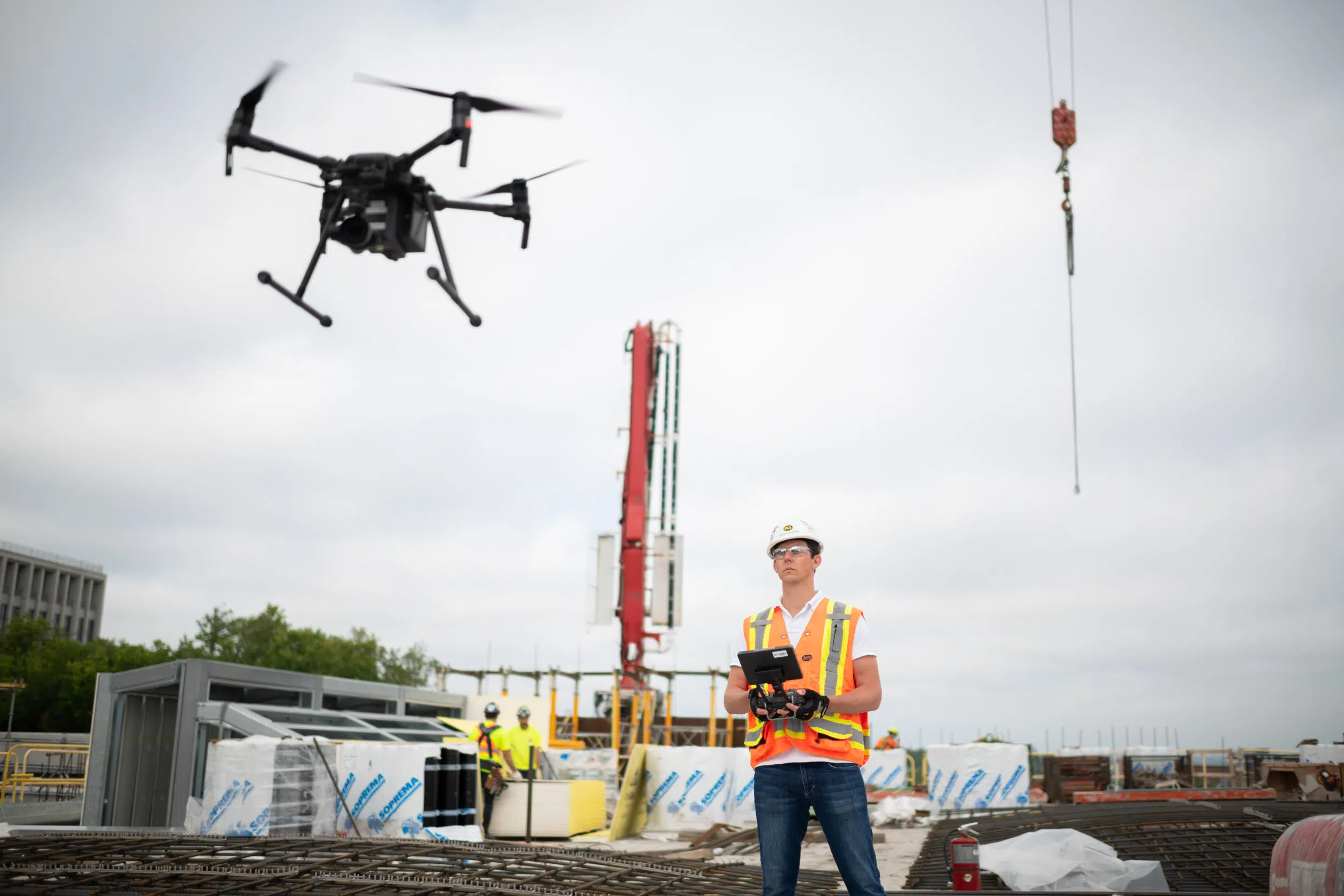 Construction drone pilot flys industrial drone.