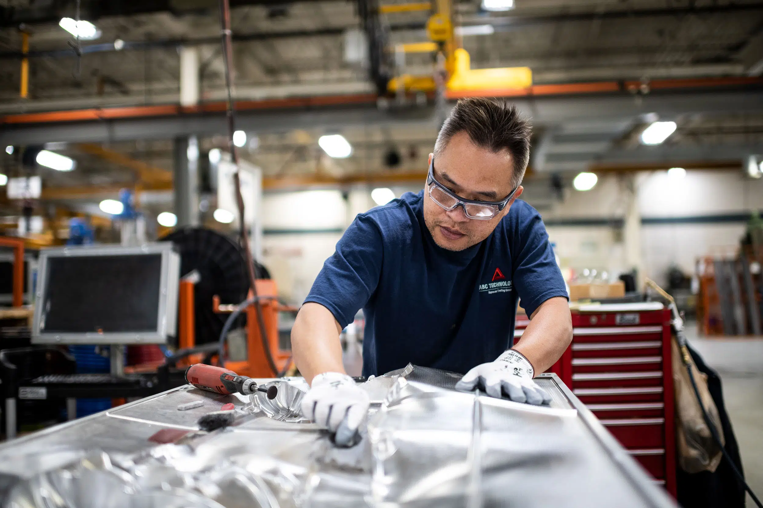 A machinist polishes a mold for automobile parts.