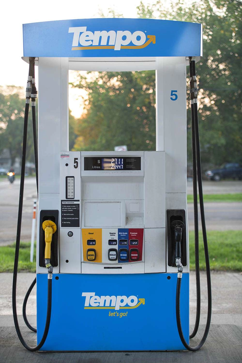 Sun rising behind the gas pump, with a motorcycle in the background, priceless. © robert lowdon