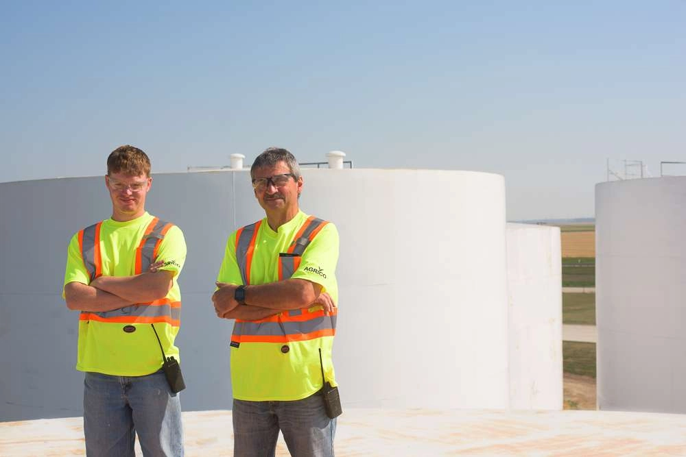 Blog - Industrial Photographer Robert Lowdon 2 Two people stand on top of large storage tank at an industrial facility