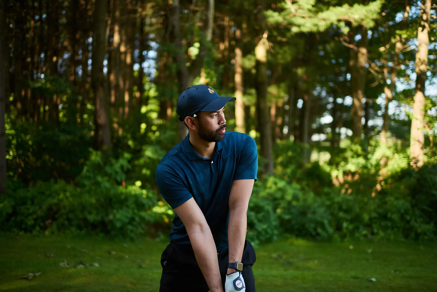 A golfer looks down the fairway as he prepares to tee off.