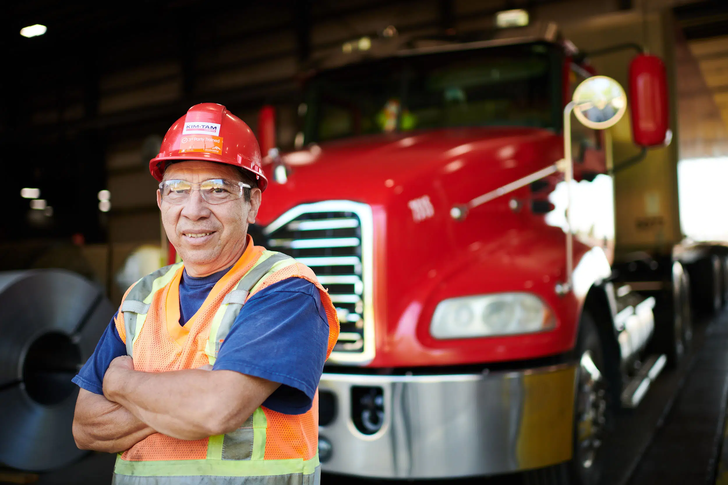 Truck driver in front of a truck.