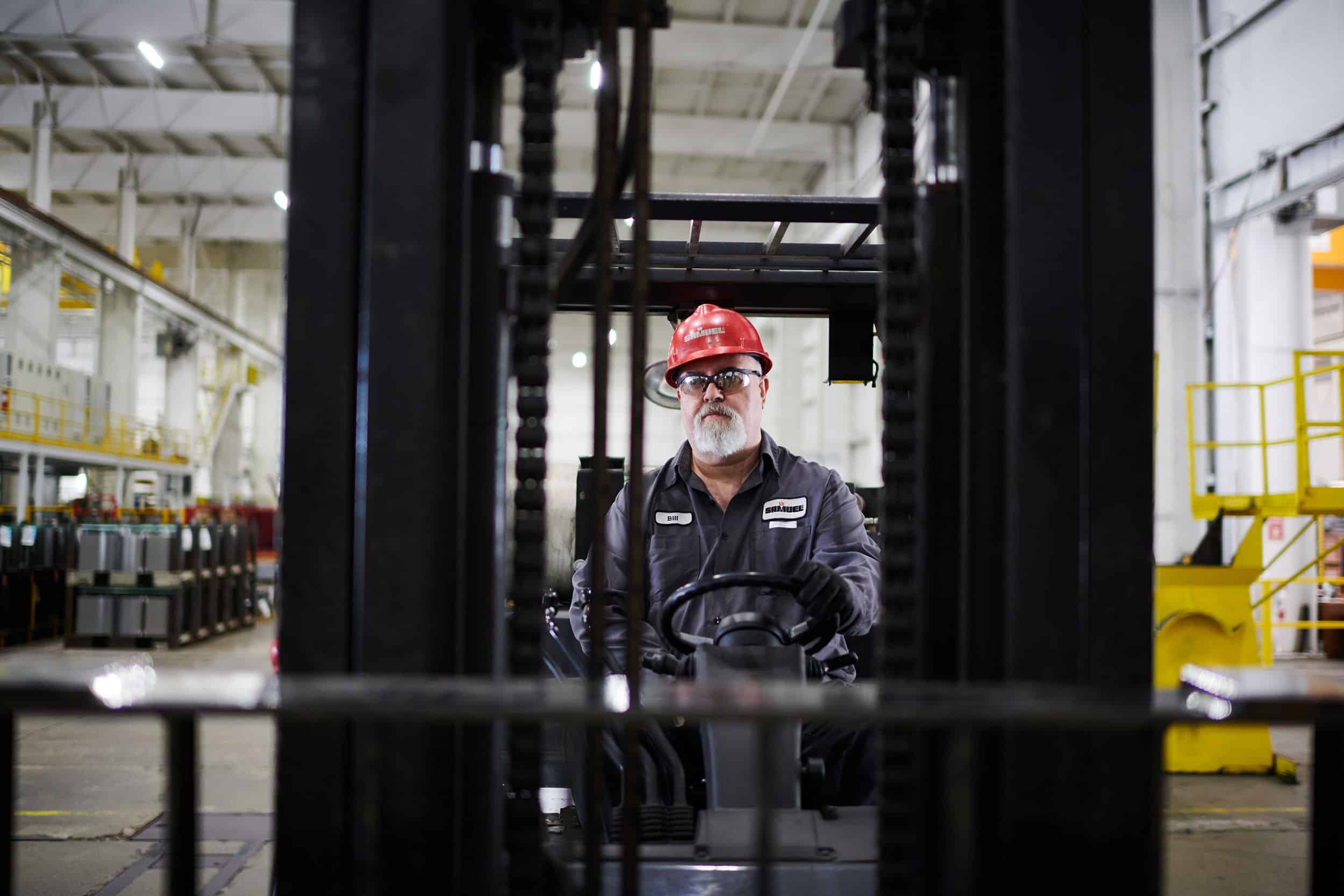 A forklift operator on the factory floor.