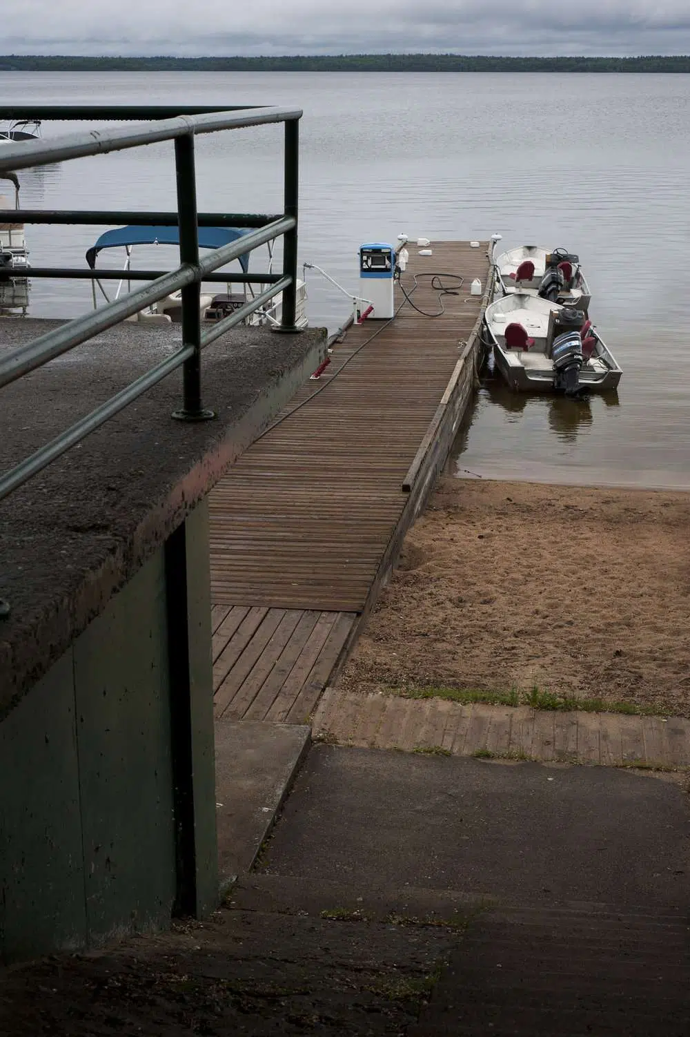 A rainy day a the dock in west hawk lake © robert lowdon